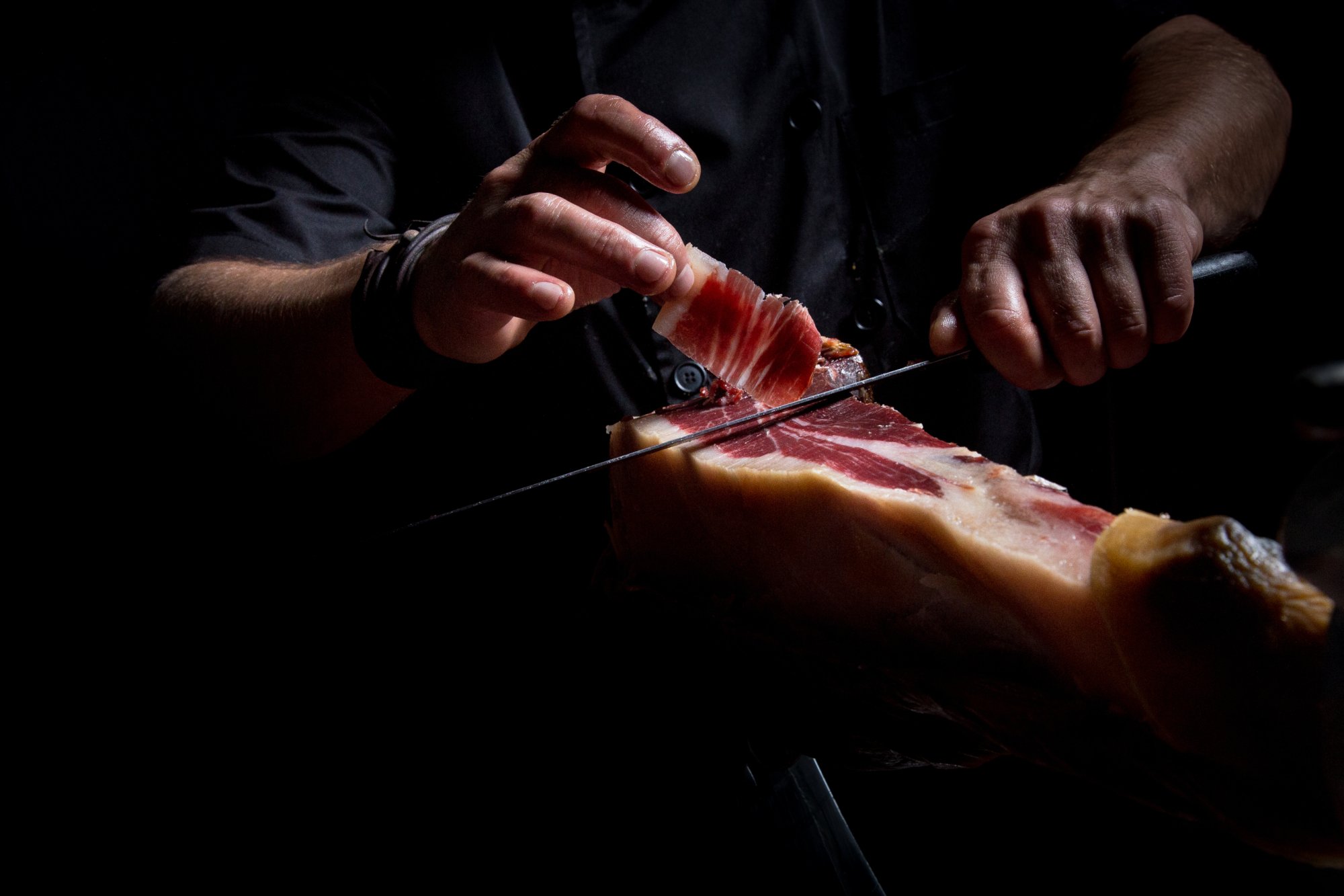Cutting ham with a knife