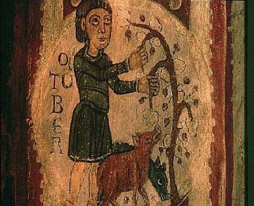 A medieval peasant feeding acorns to pigs