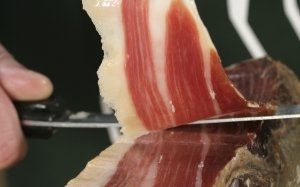 Close shot of the slicing of an Iberico bellota ham